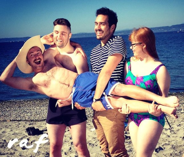 The cast poses at the beach
