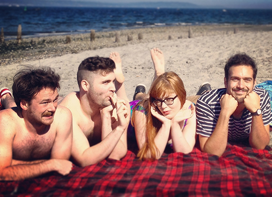 A promotional shot of the entire cast at the beach